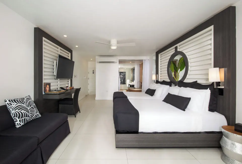 Junior Suite Ocean View guest room with king bed and seating at S Hotel Montego Bay.