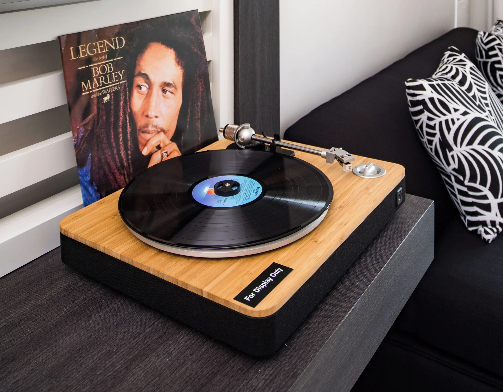 Turntable and vinyl record beside a lounge seat in a suite at S Hotel Montego Bay.