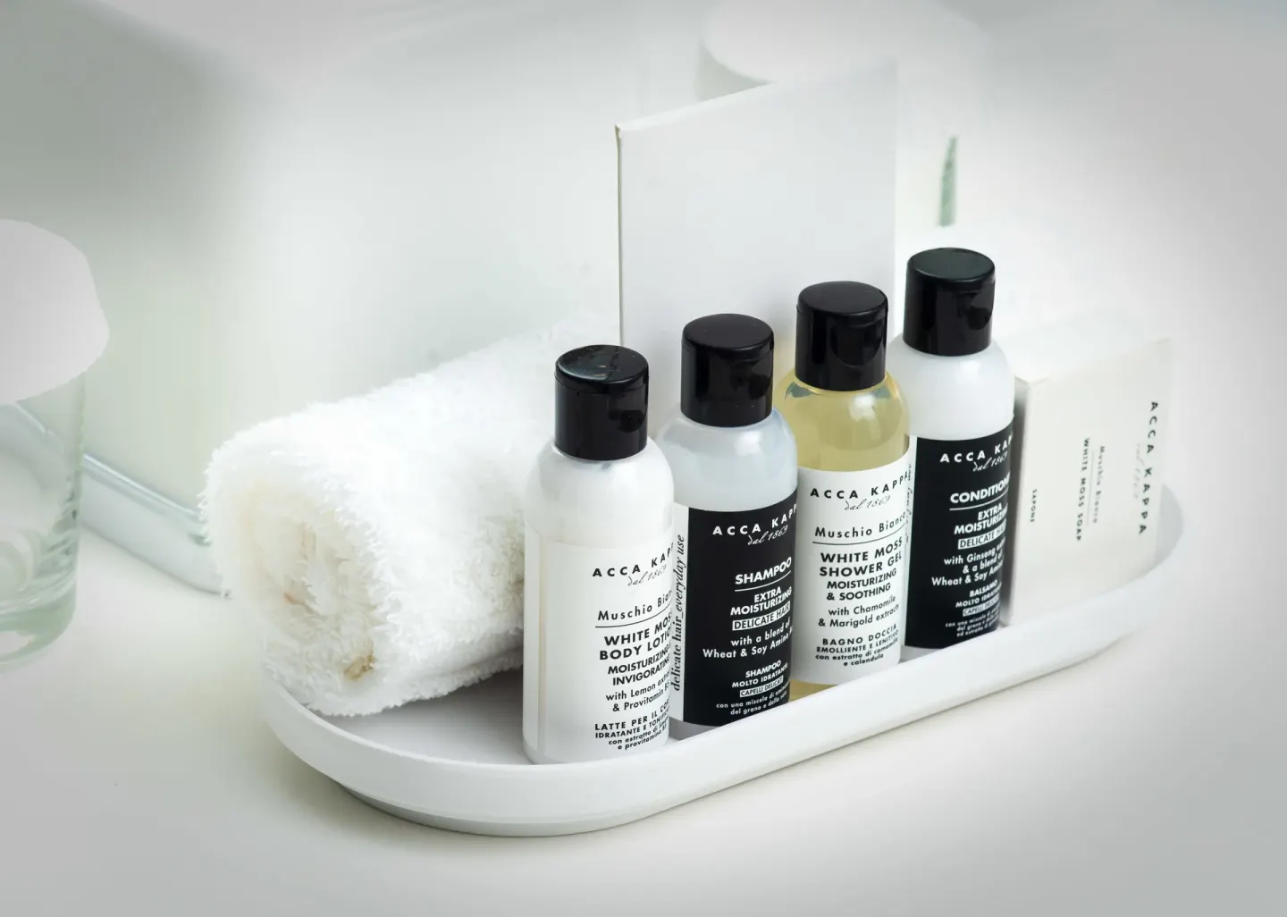 Bathroom amenity bottles and a rolled towel in a Mini Room at S Hotel Montego Bay.