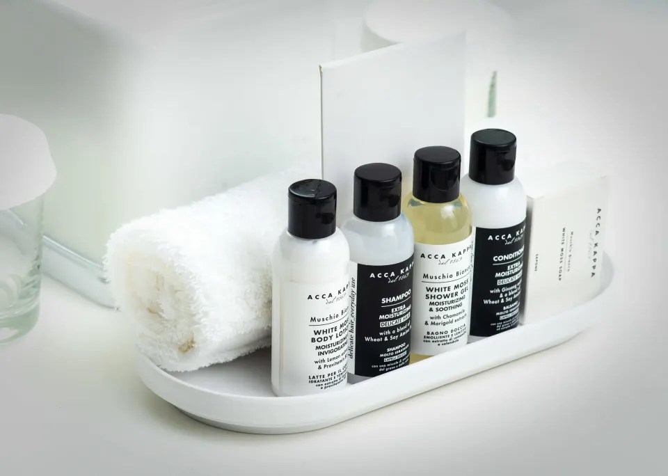 Bathroom amenity bottles and a rolled towel in a Mini Room at S Hotel Montego Bay.