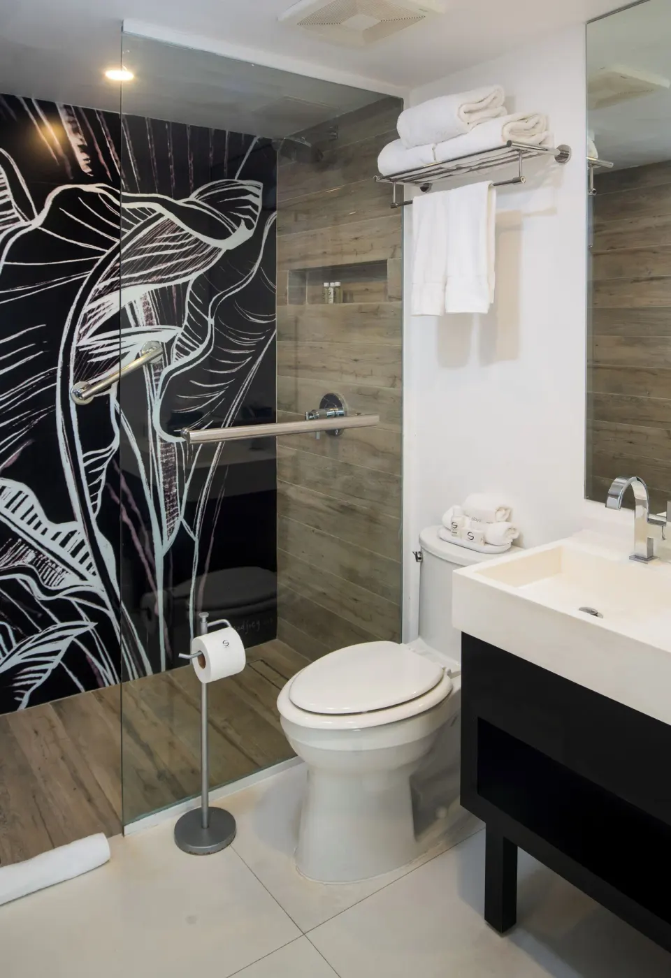 Mini Room bathroom with glass shower, toilet, vanity and towels at S Hotel Montego Bay.