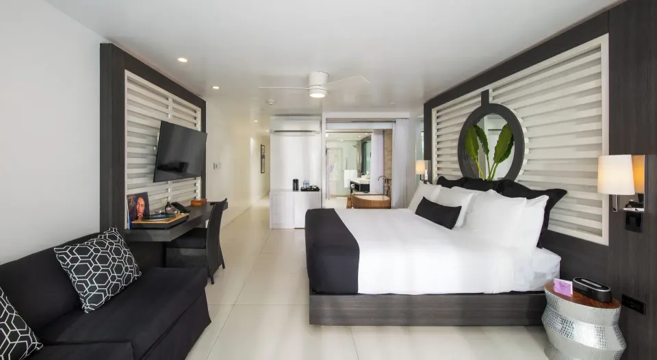 Sky Suite Ocean View guest room with king bed, sofa and desk at S Hotel Montego Bay.