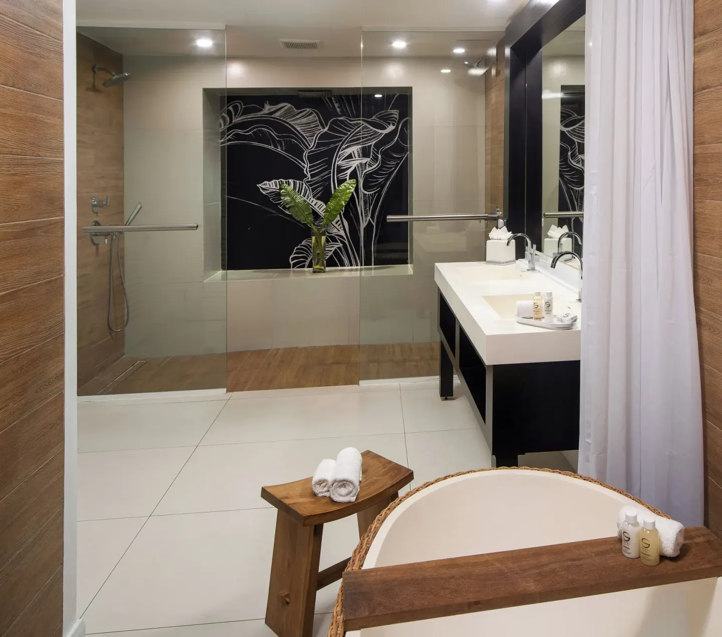 Ocean View Suite bathroom with soaking tub and glass shower at S Hotel Montego Bay.