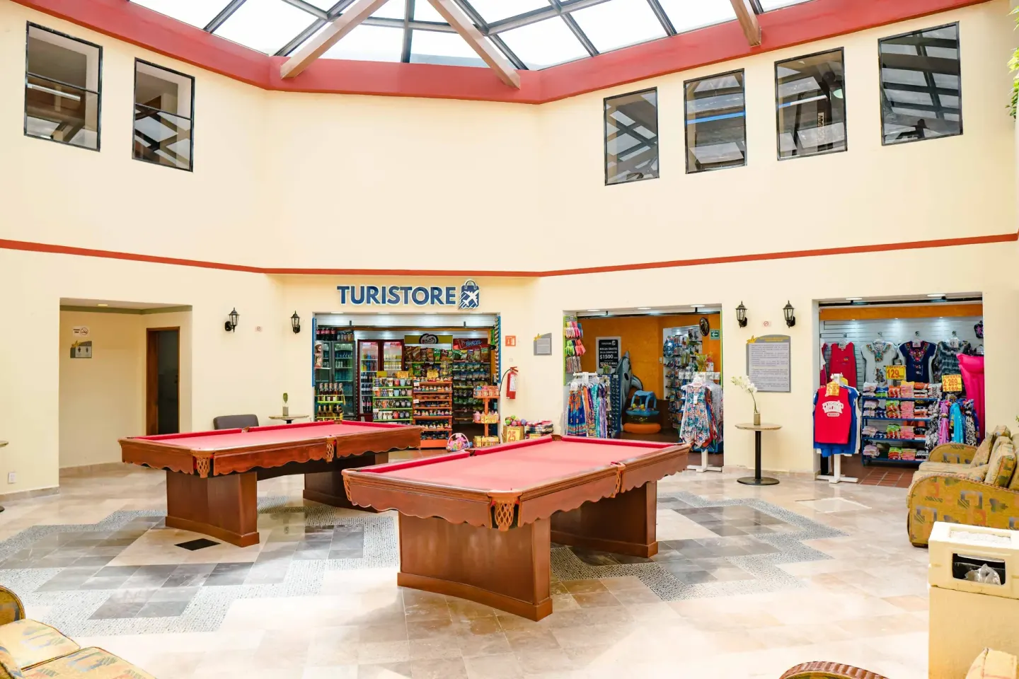 Indoor resort atrium with pool tables and shops at Samba Vallarta.