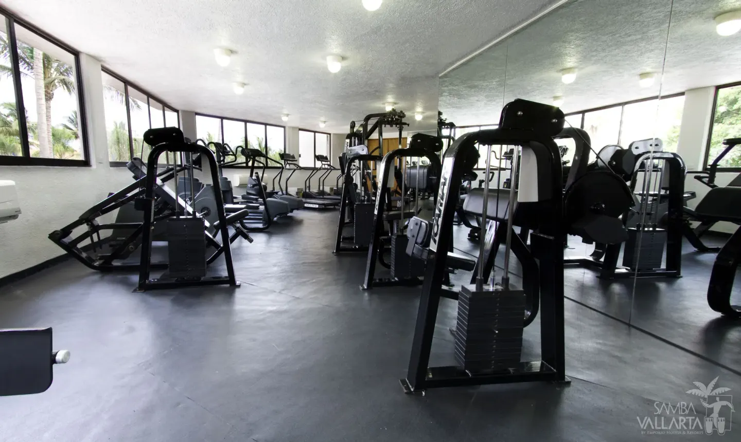 Fitness center with weight machines and cardio equipment at Samba Vallarta.