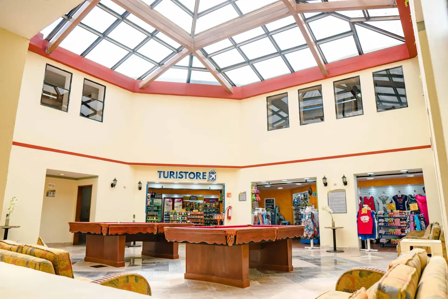 Indoor atrium with pool tables, shop fronts and skylight at Samba Vallarta.