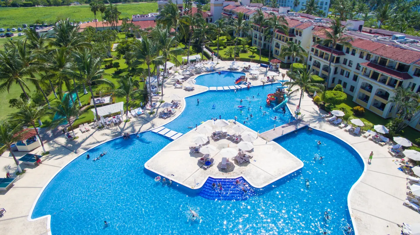 Aerial view of the pool courtyard and palm-lined buildings at Samba Vallarta.