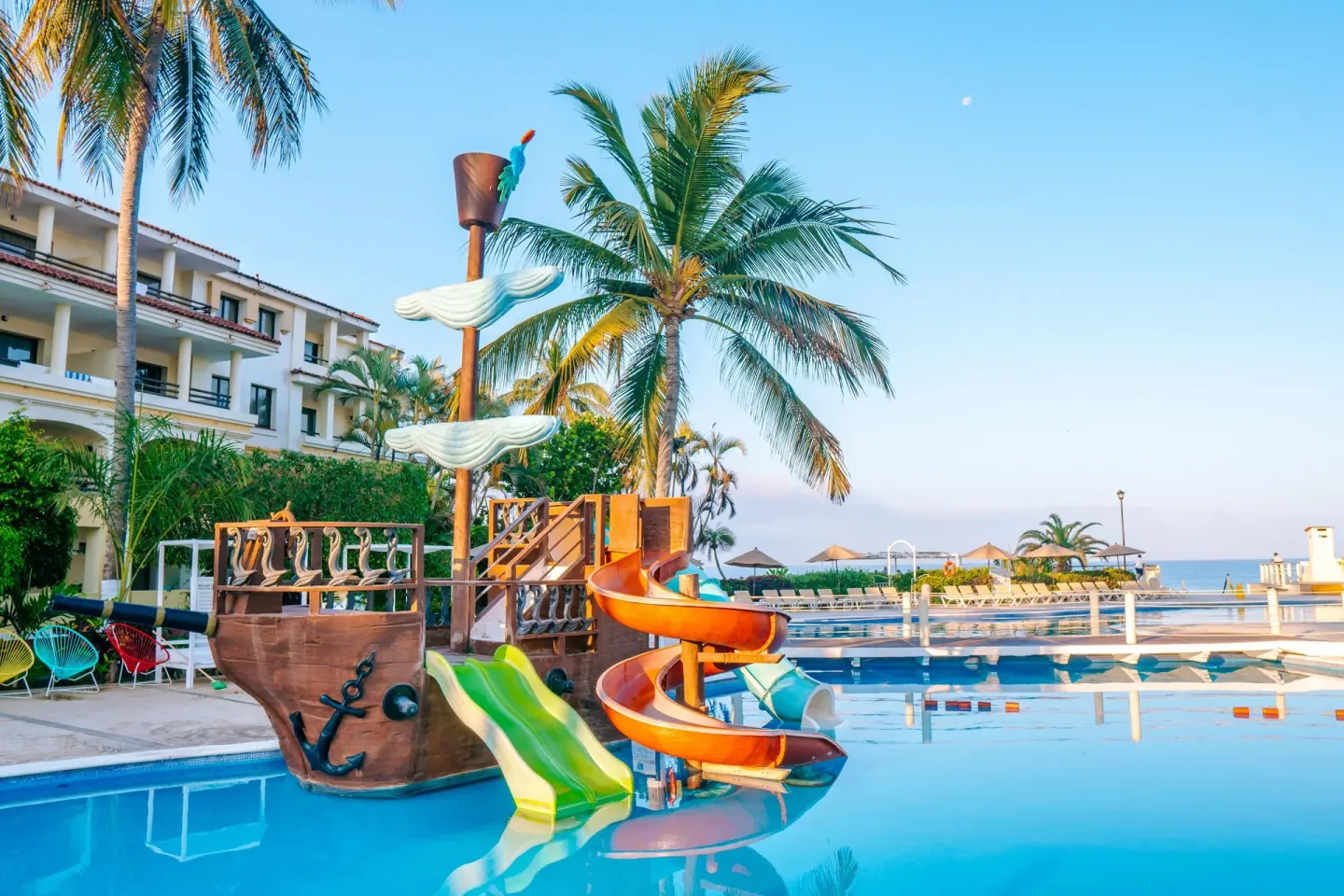 Ship-themed pool slides with ocean beyond at Samba Vallarta.