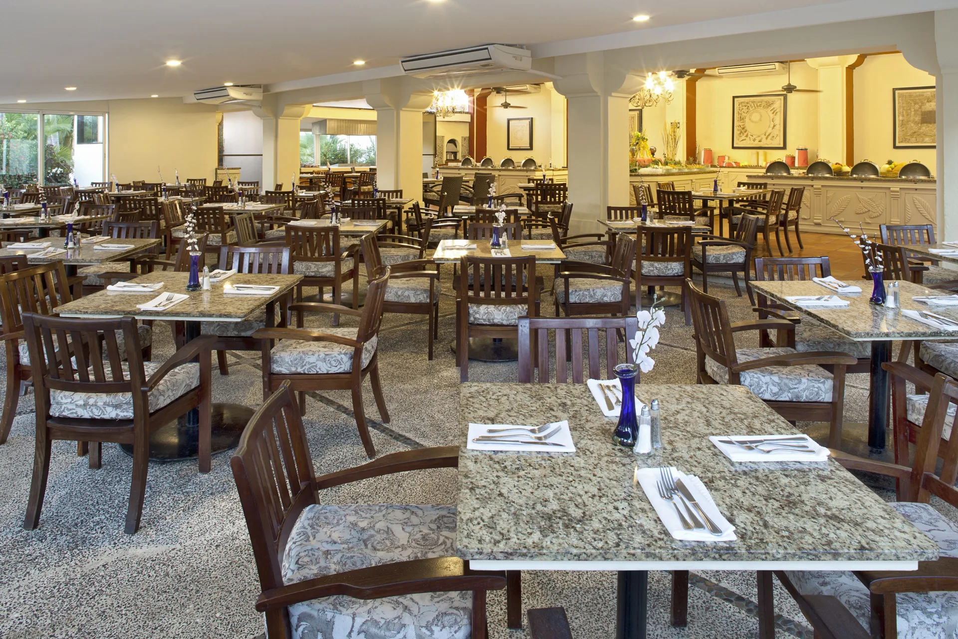 Buffet dining room with set tables and serving counter at Samba Vallarta.