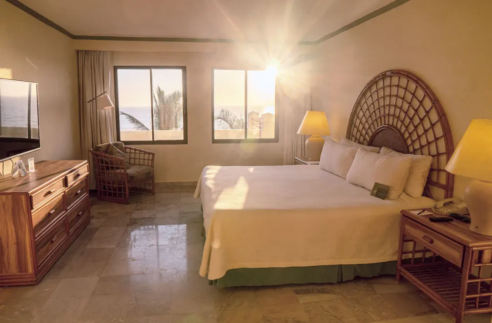 Junior Suite Ocean Front bedroom with king bed and ocean-facing windows at Samba Vallarta.