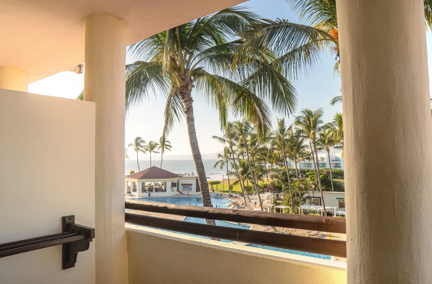 Standard Room balcony view of palms, pool, and ocean at Samba Vallarta.