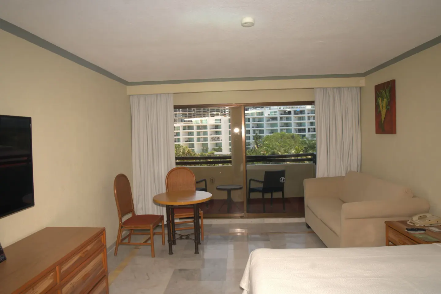 Standard Room with balcony seating and a bed corner at Samba Vallarta.