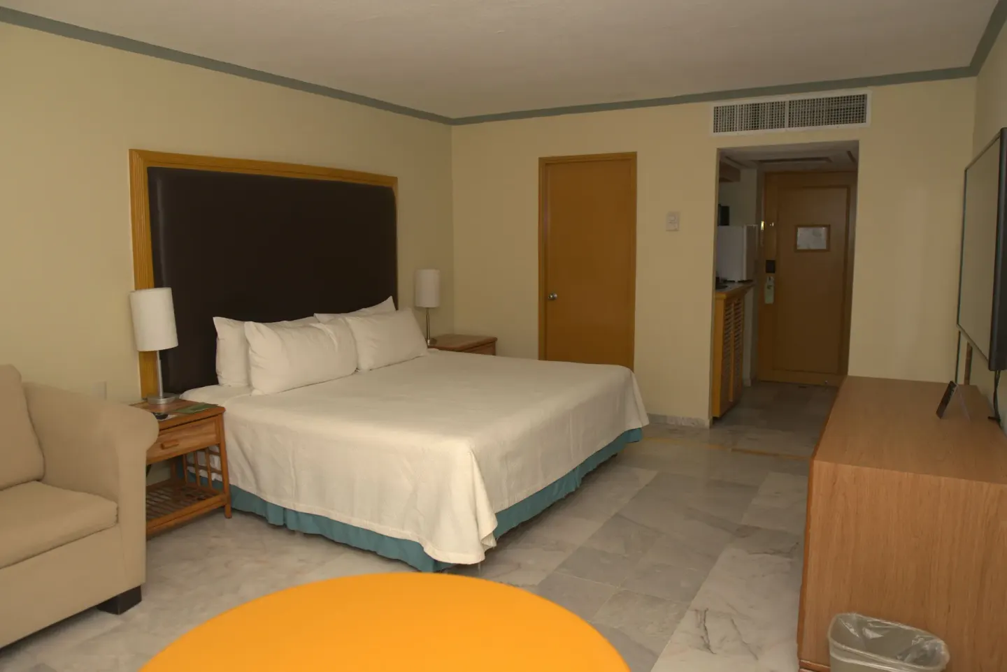Standard Room with a king bed, sofa, dresser, and TV at Samba Vallarta.
