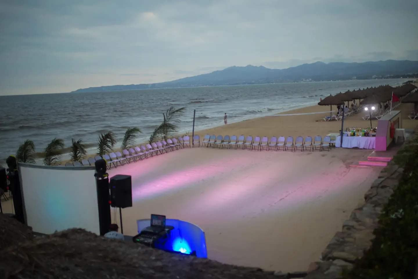 Beach event area with chairs, lights, and ocean backdrop at Samba Vallarta.