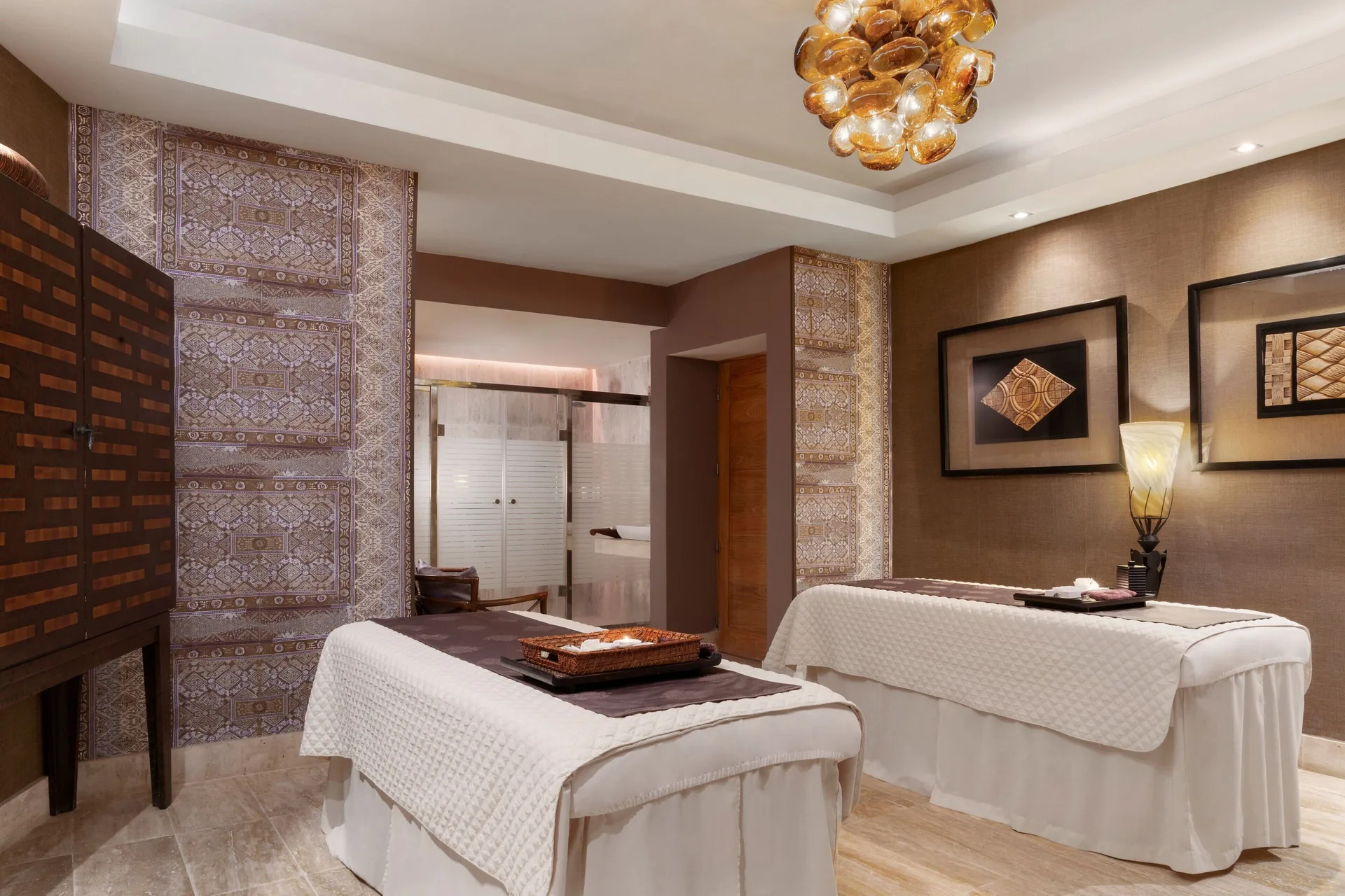 Spa treatment room with two massage tables at Sanctuary Cap Cana, a Luxury Collection Resort.
