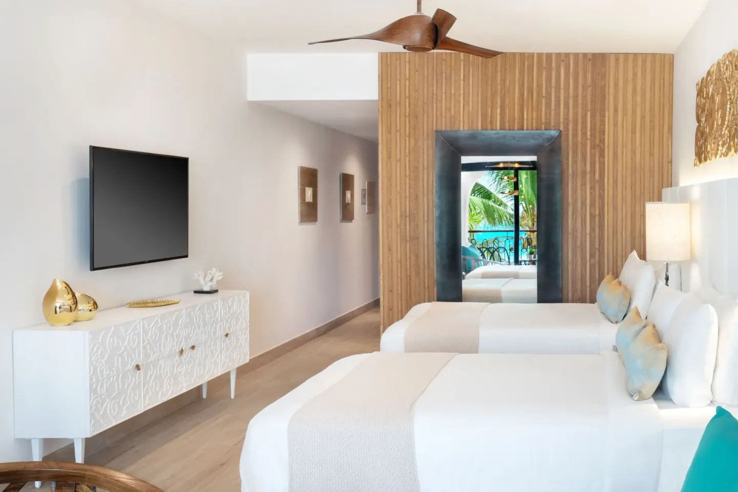 Twin-bed guest room with balcony glimpse at Sanctuary Cap Cana, a Luxury Collection Resort.