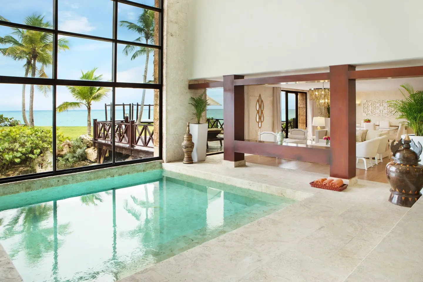 Indoor plunge pool and ocean-view lounge at Sanctuary Cap Cana, a Luxury Collection Resort.