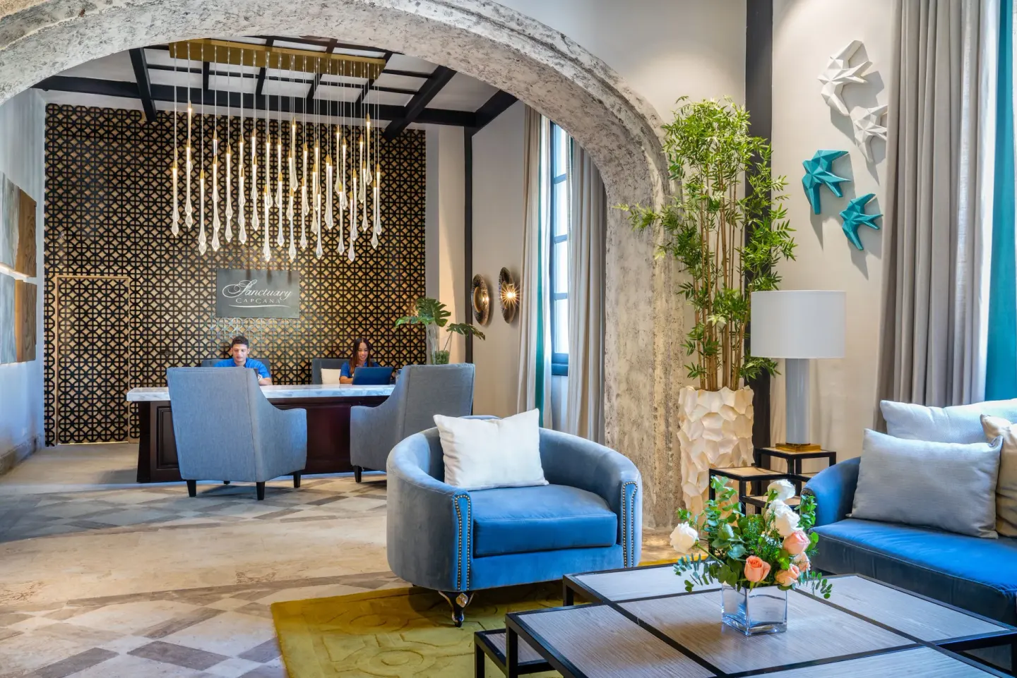 Lobby seating and front desk at Sanctuary Cap Cana, a Luxury Collection Resort.