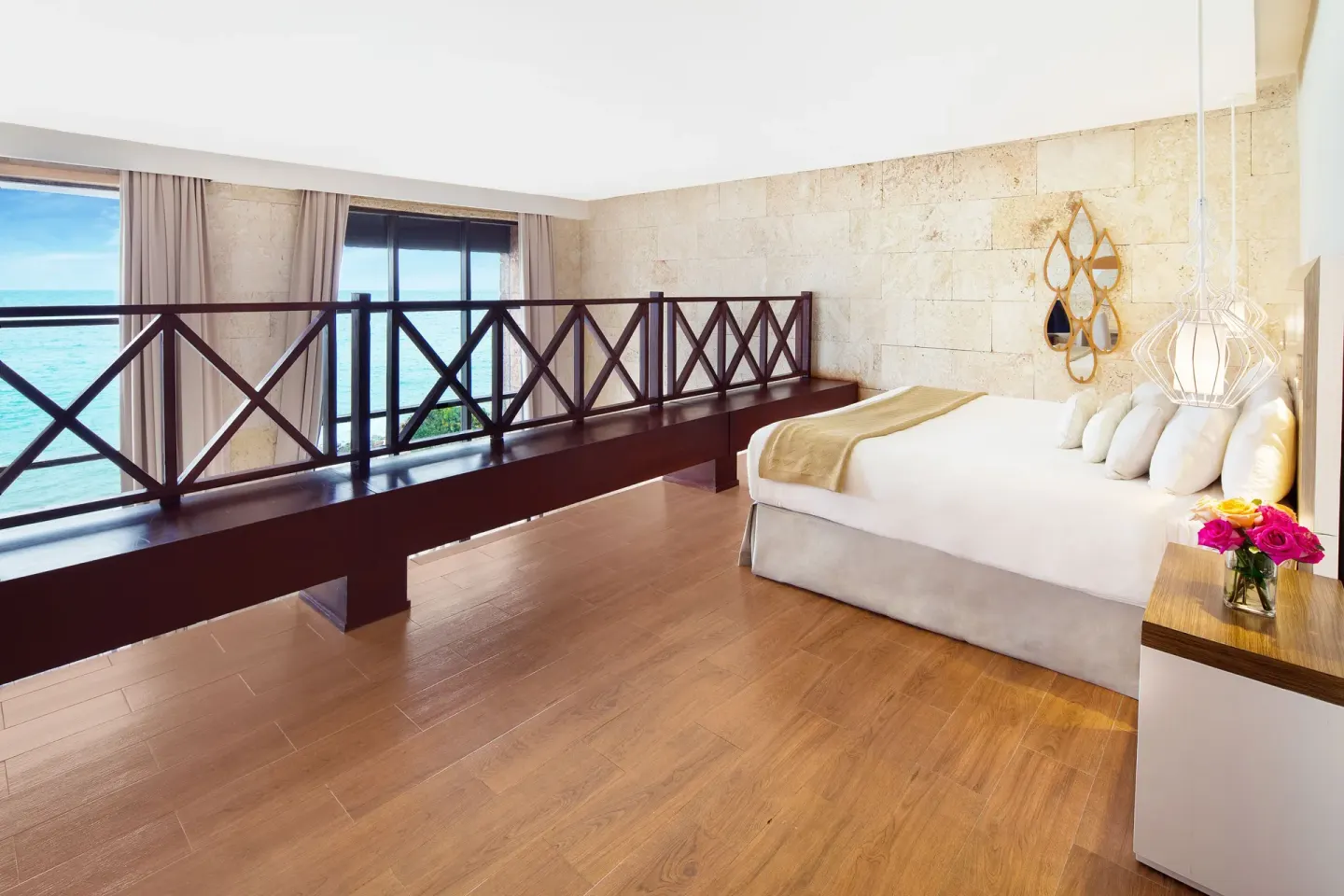 Loft-style guest room with bed and ocean windows at Sanctuary Cap Cana, a Luxury Collection Resort.