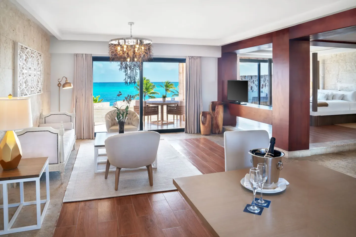 Ocean-view suite living area and bedroom at Sanctuary Cap Cana, a Luxury Collection Resort.
