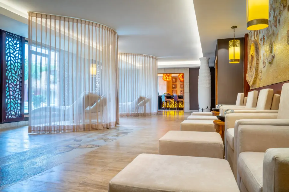 Spa relaxation lounge with cushioned chairs at Sanctuary Cap Cana, a Luxury Collection Resort.
