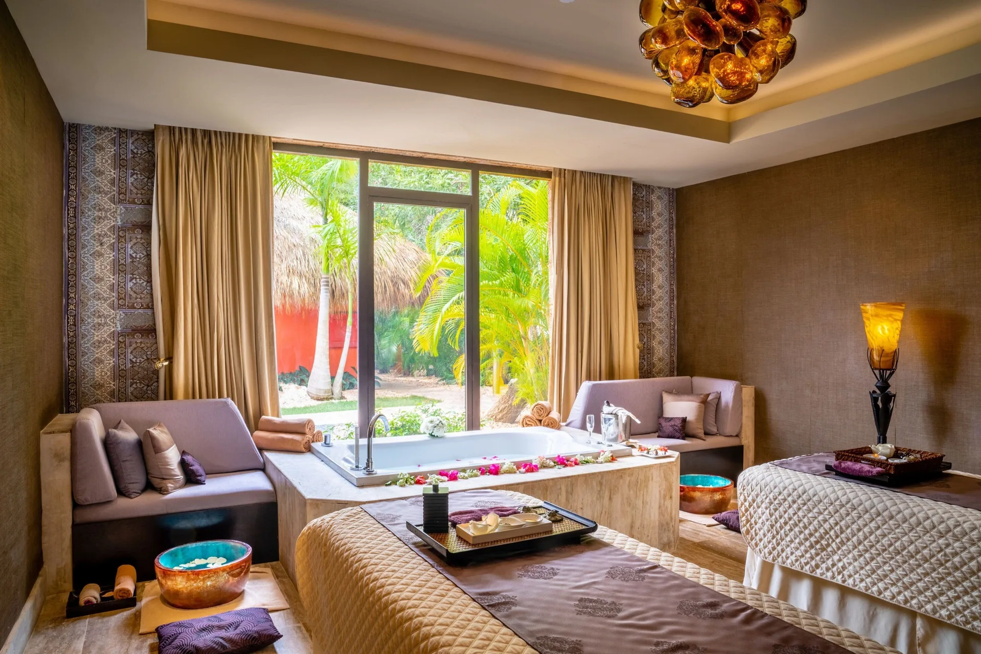 Spa treatment room with massage beds and soaking tub at Sanctuary Cap Cana, a Luxury Collection Resort.