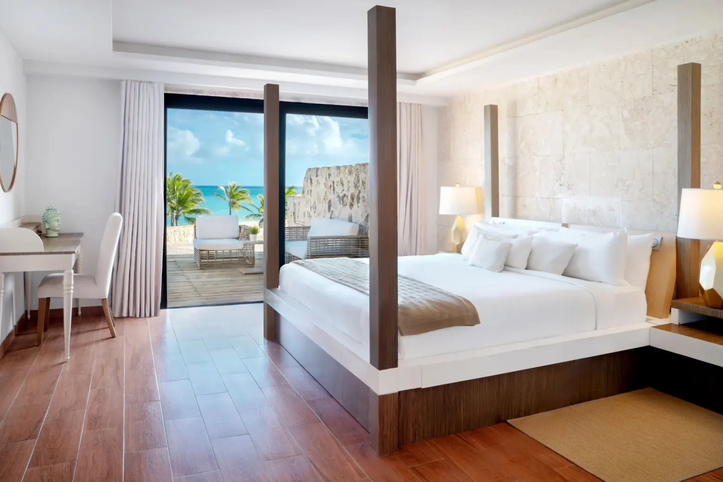Four-poster king bed with terrace view at Sanctuary Cap Cana, a Luxury Collection Resort.