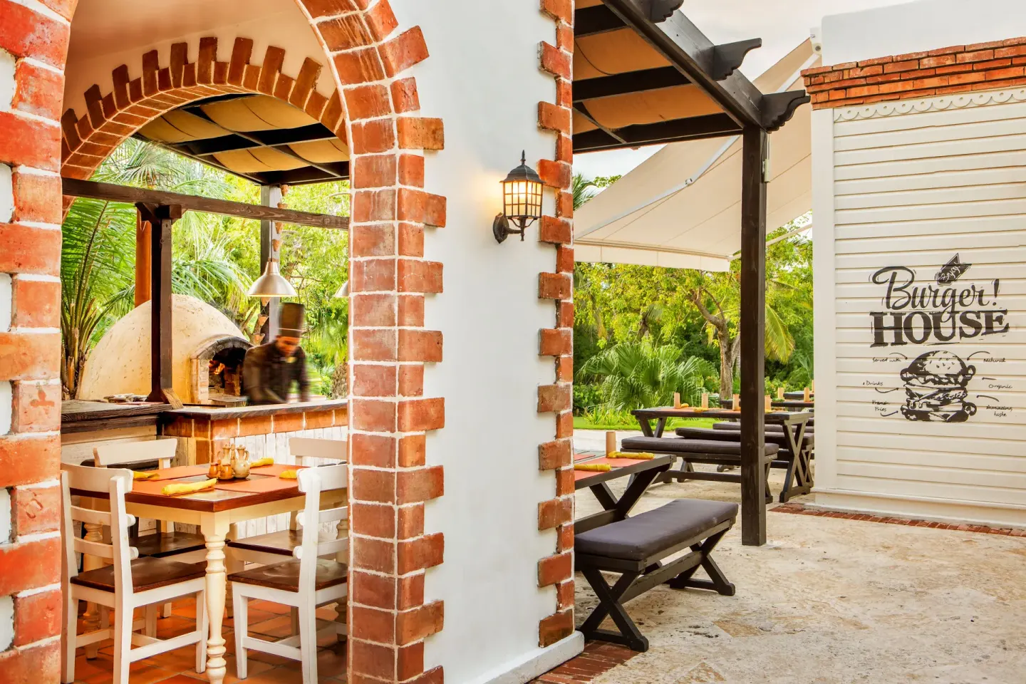A burger grill area with brick arches at Sanctuary Cap Cana, a Luxury Collection Resort.