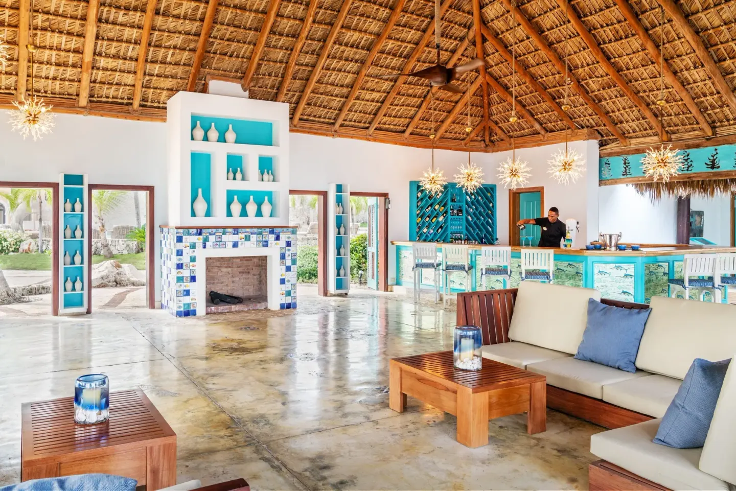 Open-air bar lounge with thatched roof at Sanctuary Cap Cana, a Luxury Collection Resort.