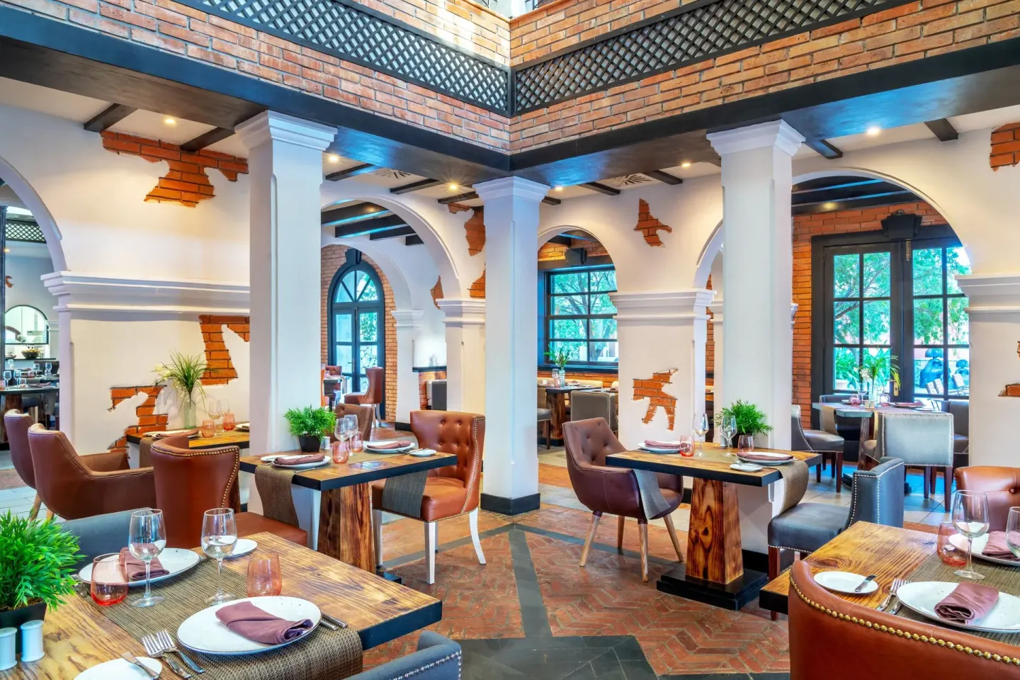 Steakhouse dining room with leather chairs at Sanctuary Cap Cana, a Luxury Collection Resort.