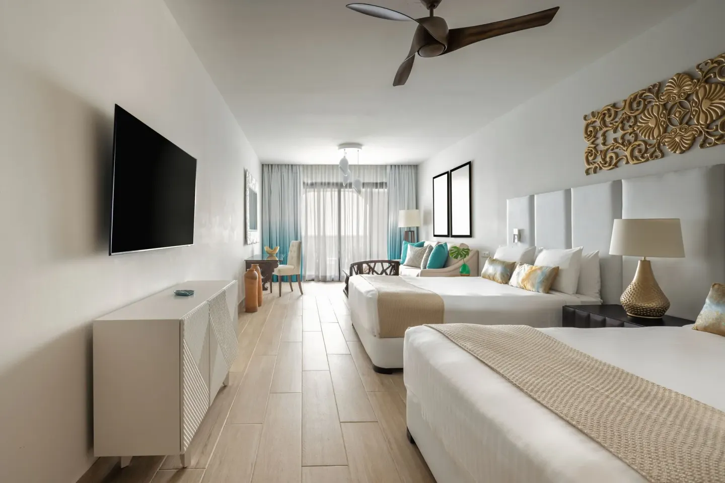 Junior Room with two beds, TV, ceiling fan, and balcony doors at Sanctuary Cap Cana, a Luxury Collection Resort.