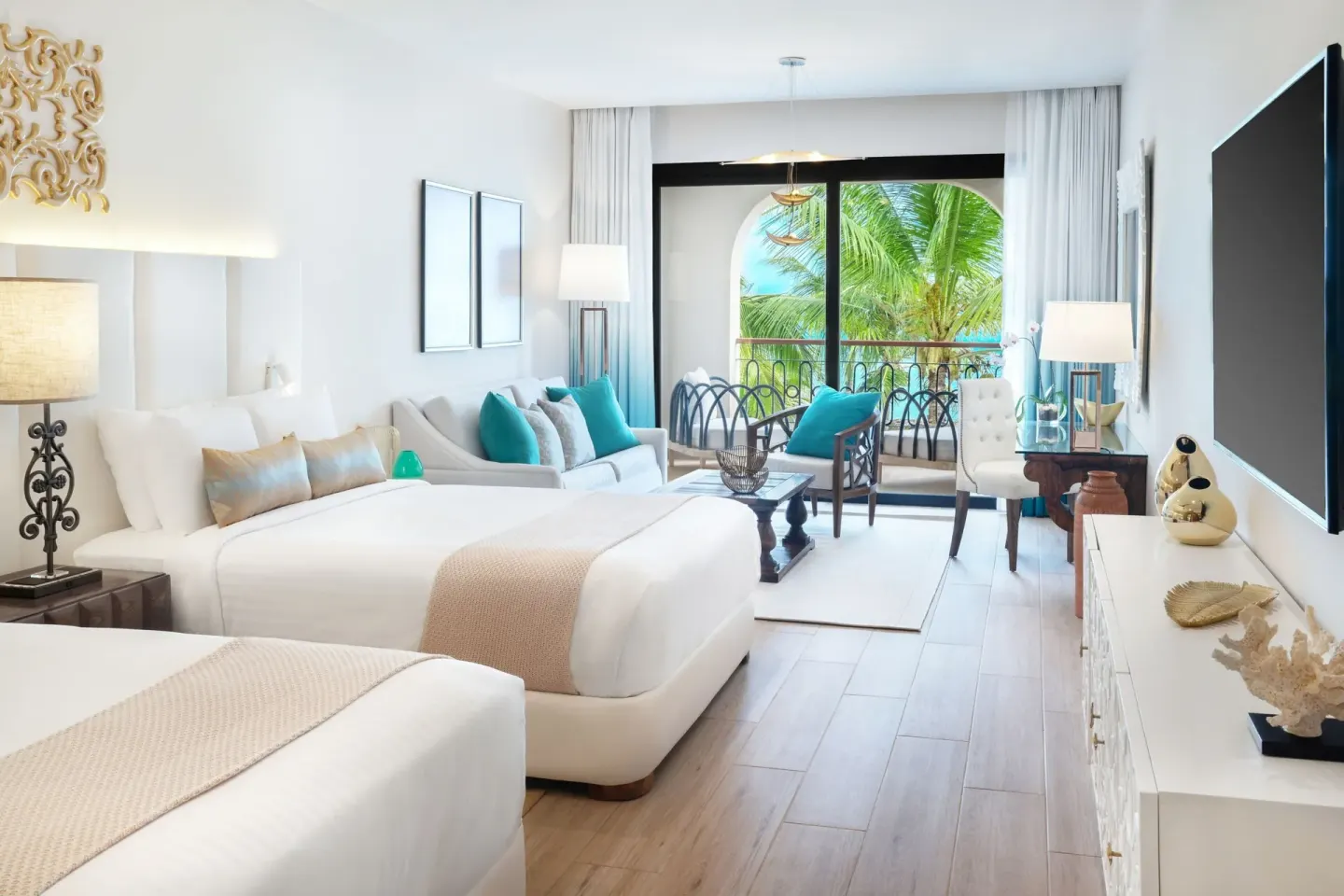 Junior Room with two beds, seating area, balcony, and palm view at Sanctuary Cap Cana, a Luxury Collection Resort.