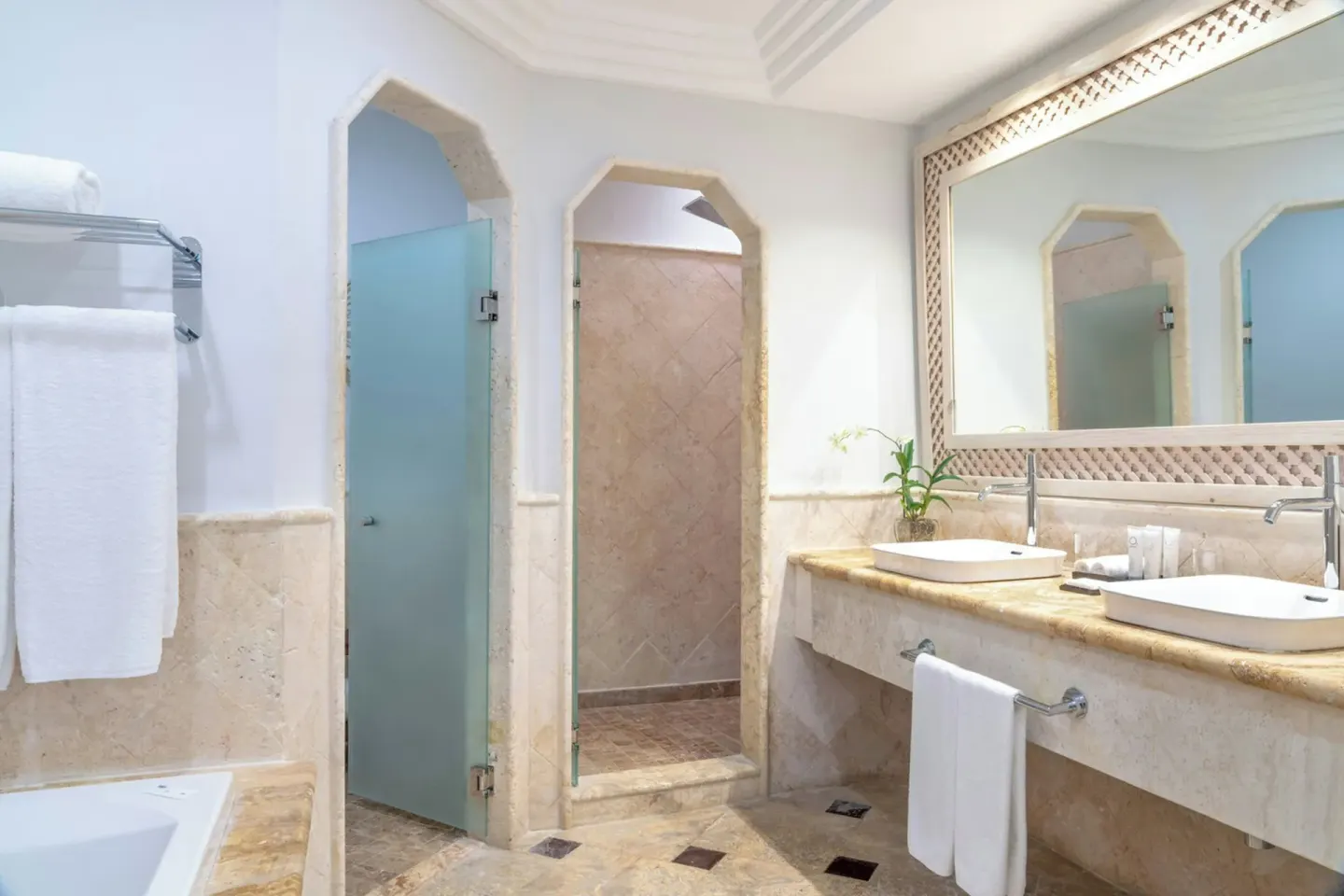 Junior Suite Beachfront bathroom with double vanity and shower at Sanctuary Cap Cana, a Luxury Collection Resort.