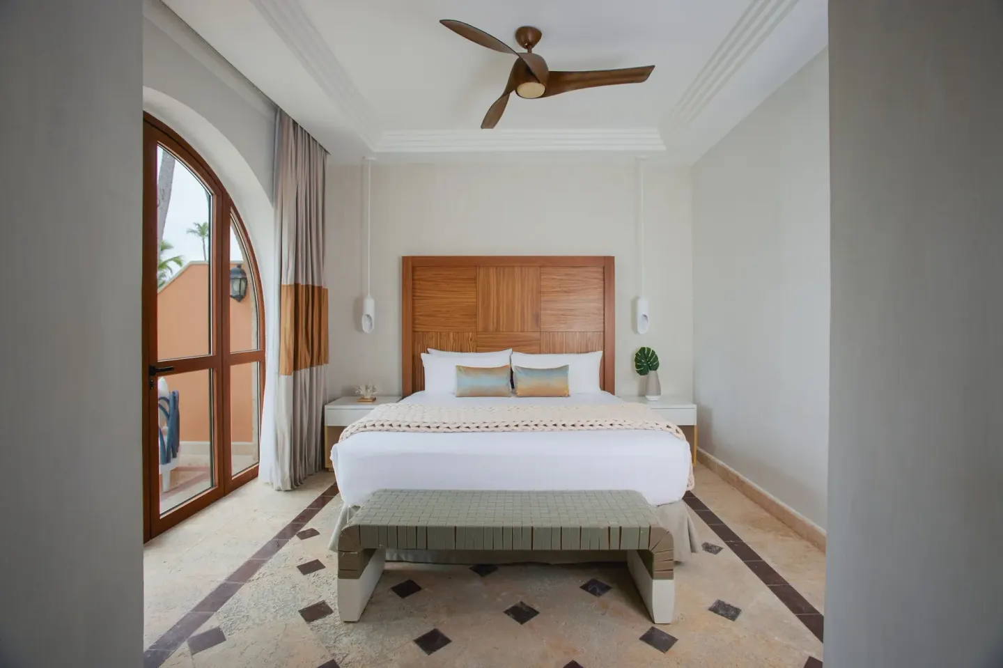Junior Suite Beachfront bedroom with king bed and balcony doors at Sanctuary Cap Cana, a Luxury Collection Resort.