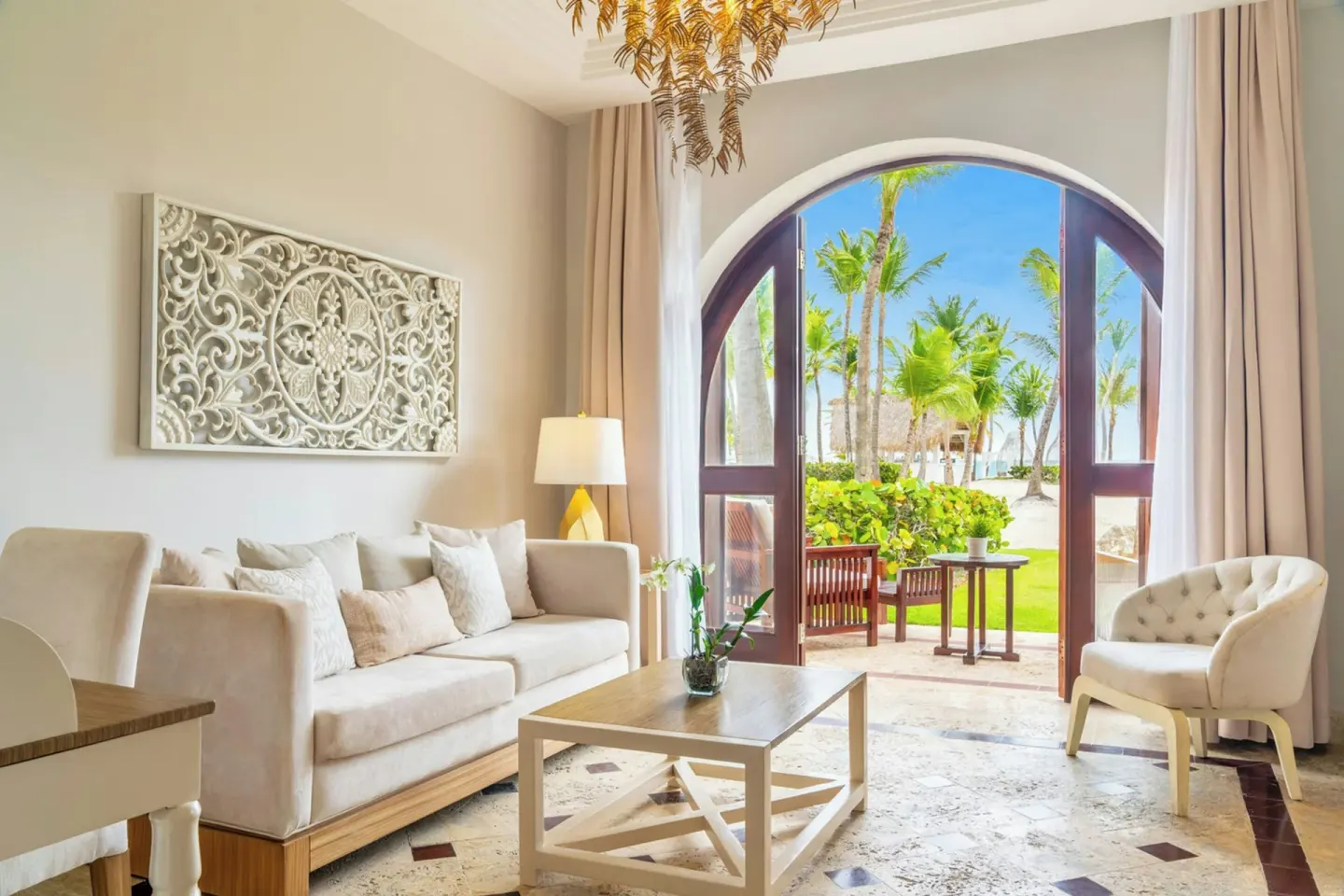Junior Suite Beachfront living area opening to palms and beach at Sanctuary Cap Cana, a Luxury Collection Resort.