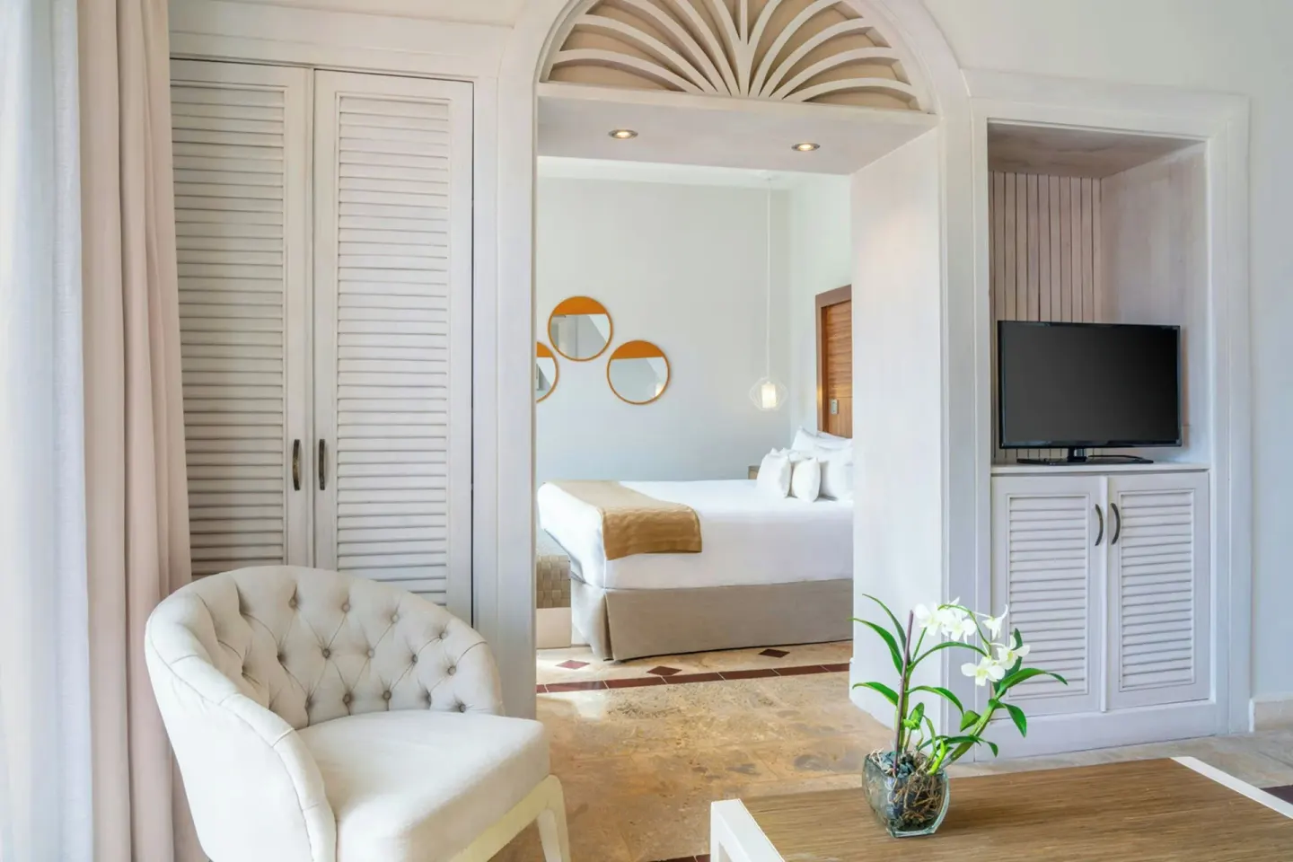 Junior Suite Beachfront sitting area with bedroom beyond at Sanctuary Cap Cana, a Luxury Collection Resort.