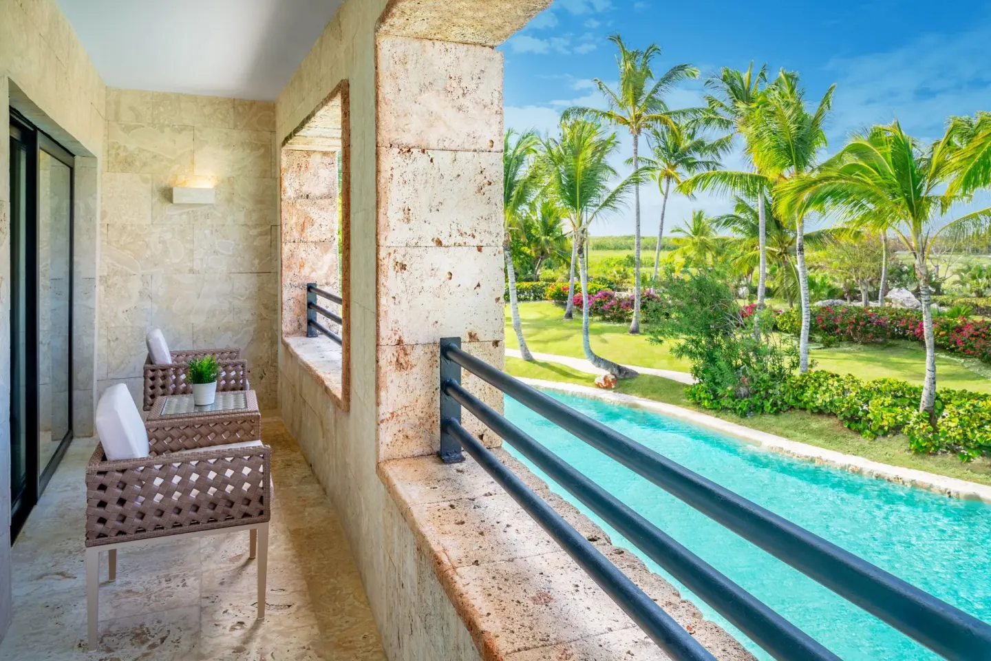 Junior Suite Balcony Garden View balcony with chairs at Sanctuary Cap Cana, a Luxury Collection Resort.