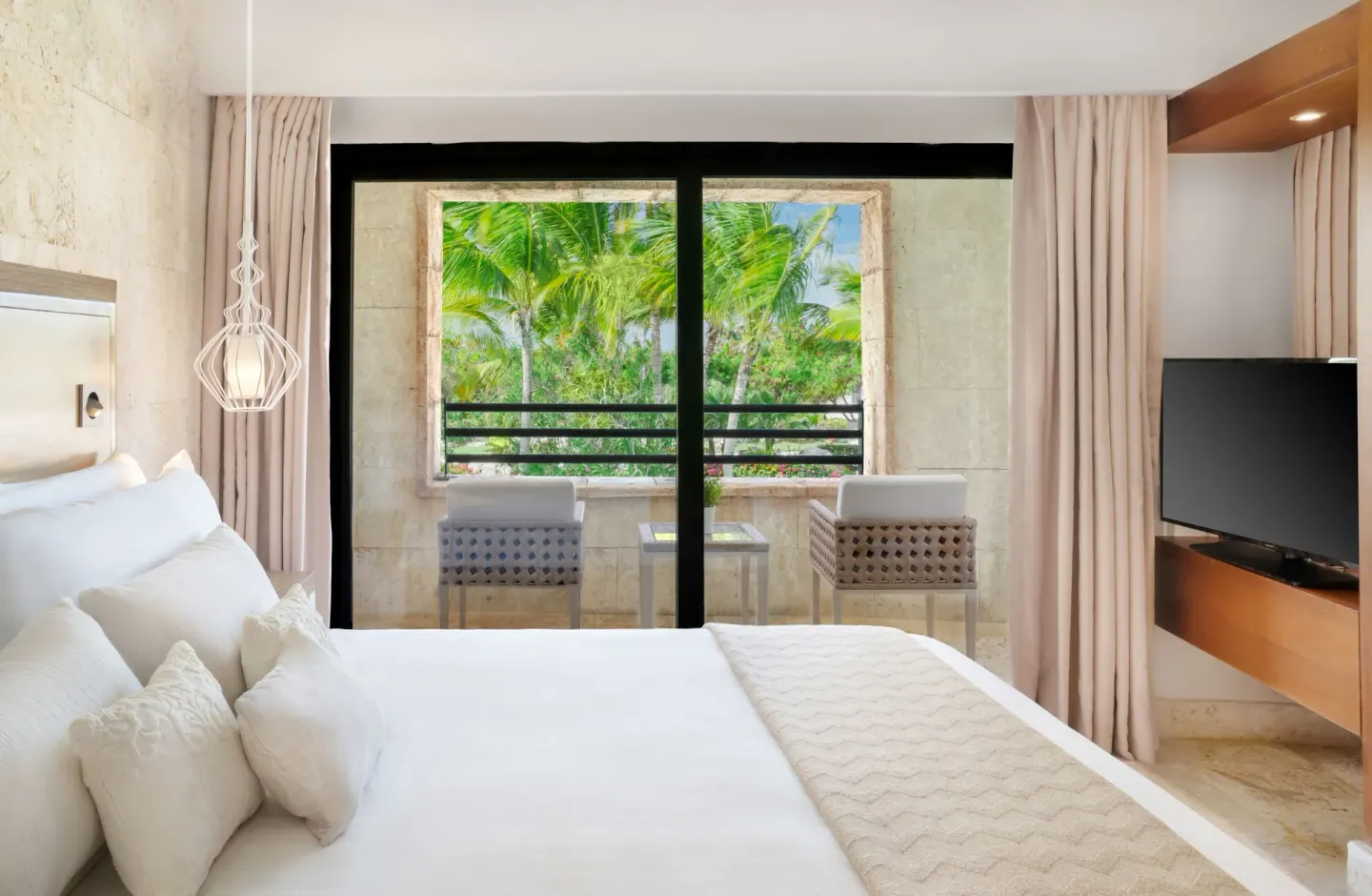Junior Suite Balcony Garden View bedroom with balcony at Sanctuary Cap Cana, a Luxury Collection Resort.