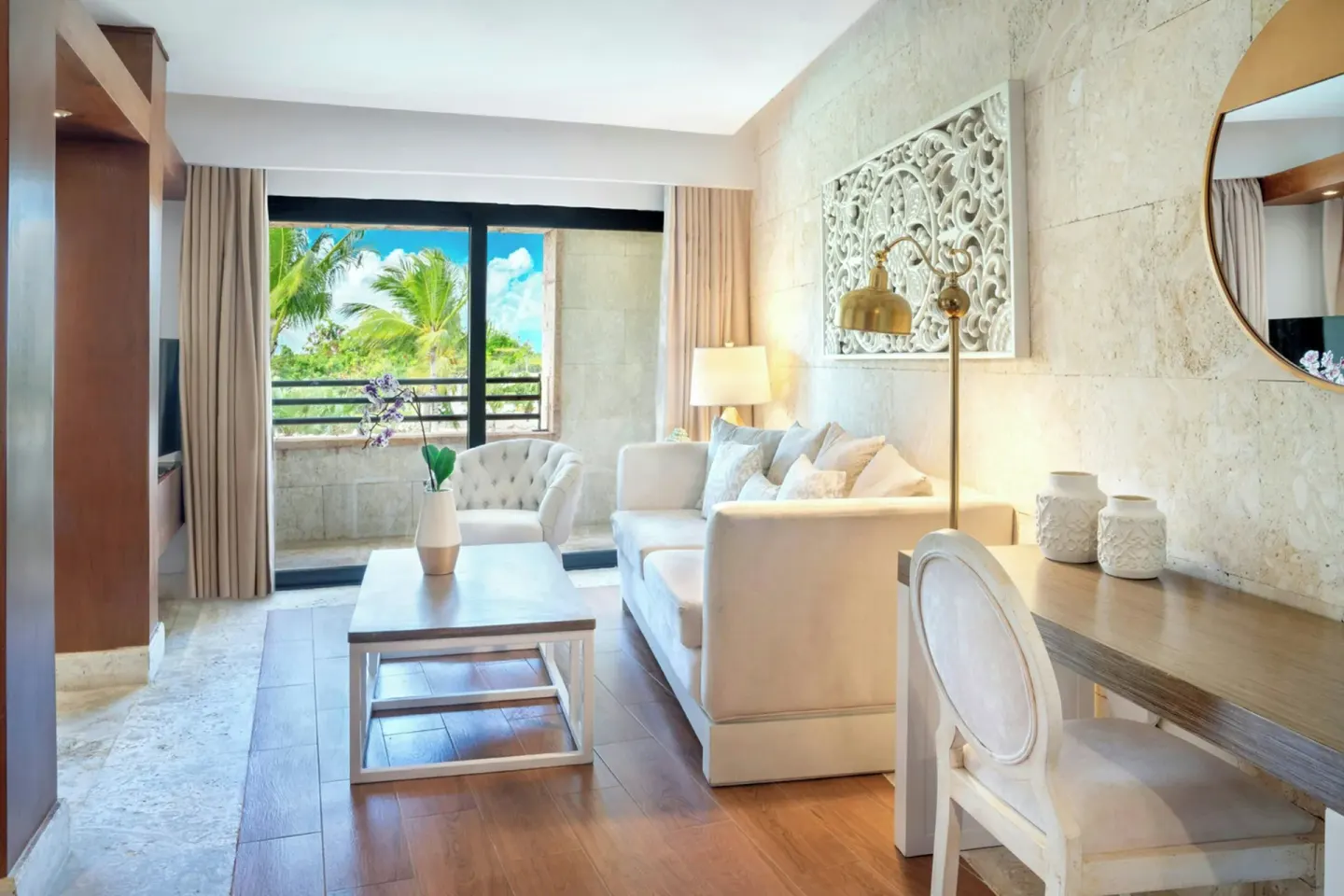 Junior Suite Balcony Garden View living area with sofa at Sanctuary Cap Cana, a Luxury Collection Resort.