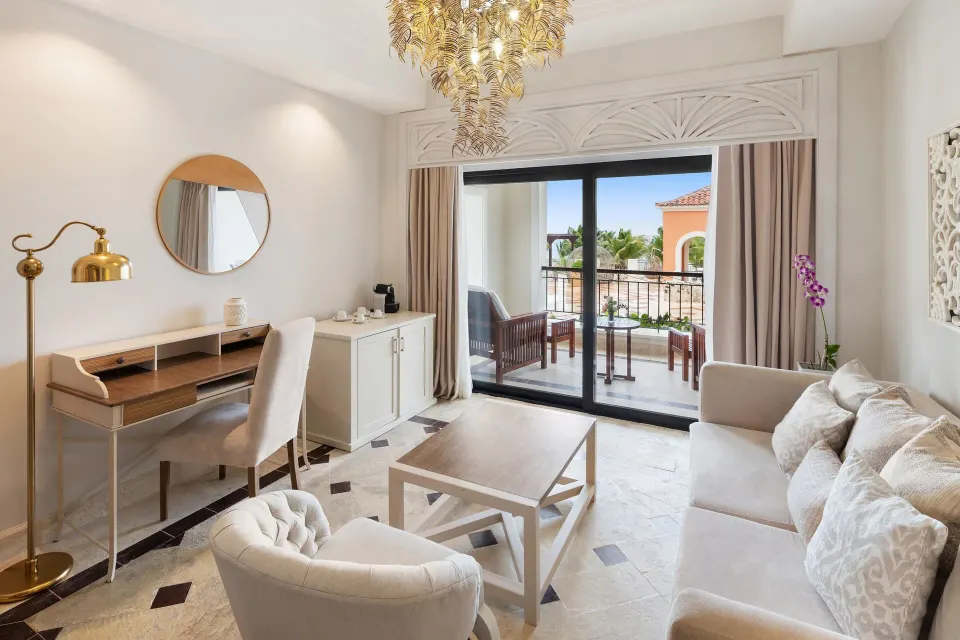 Junior Suite living area with balcony at Sanctuary Cap Cana, a Luxury Collection Resort.