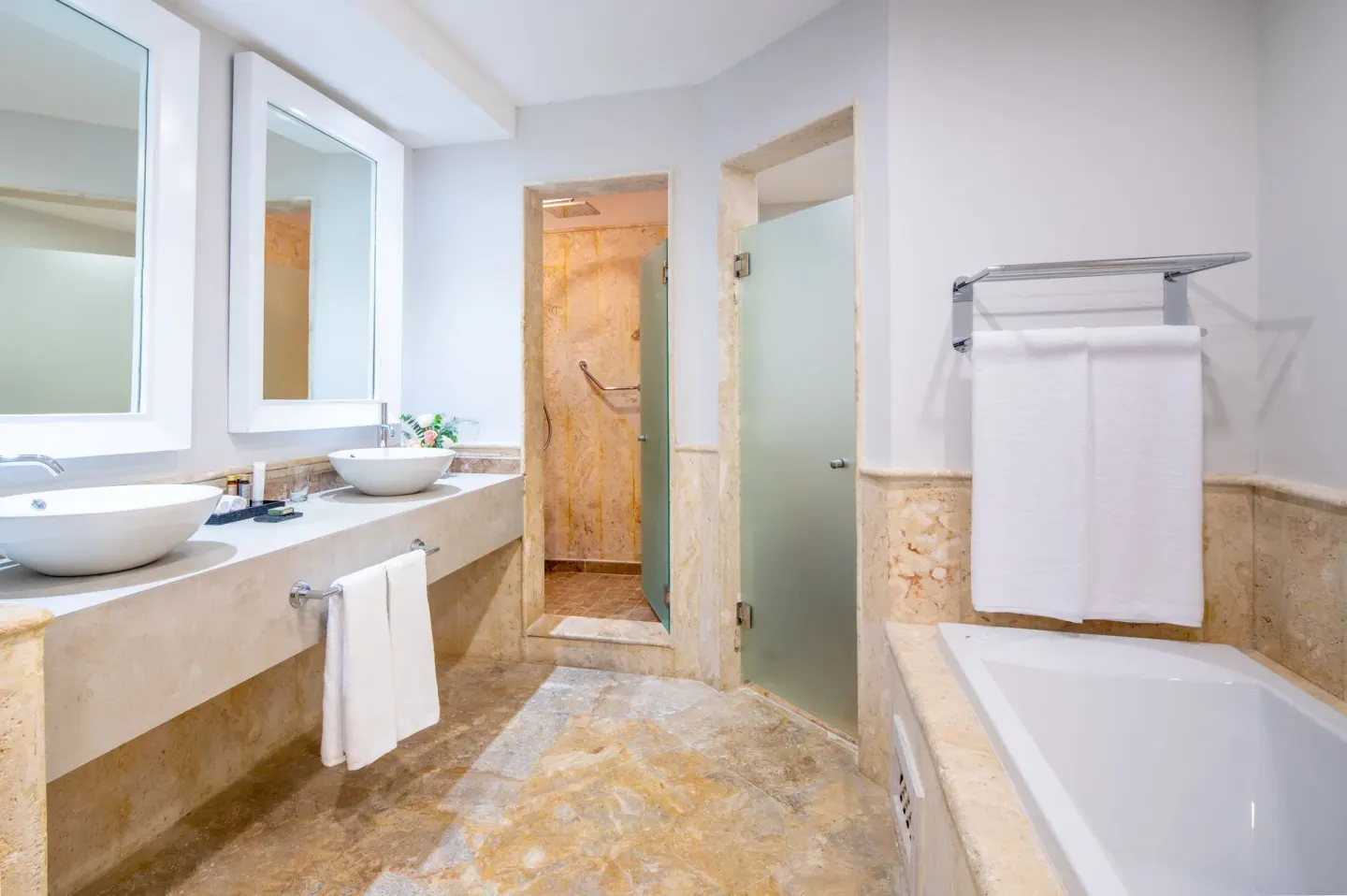 Junior Suite bathroom with tub and double sinks at Sanctuary Cap Cana, a Luxury Collection Resort.
