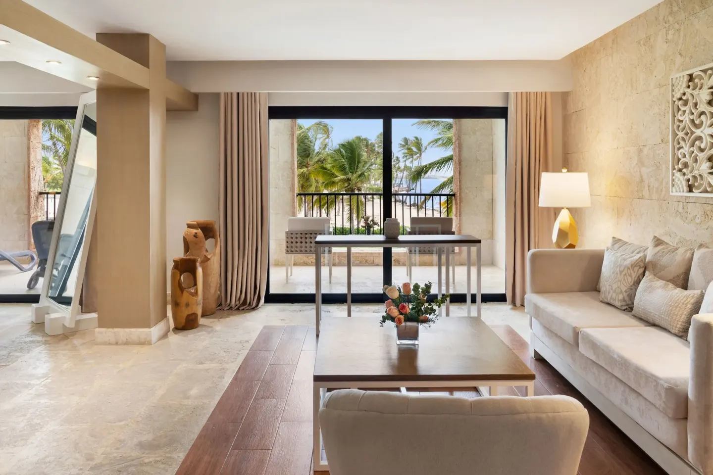 Junior Suite living area with ocean-facing balcony at Sanctuary Cap Cana, a Luxury Collection Resort.