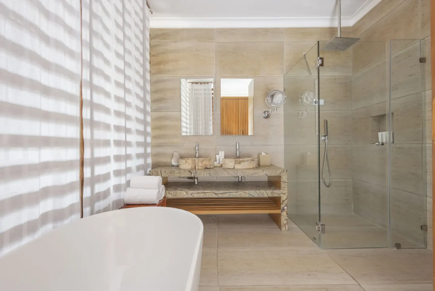 Junior Suite bathroom at Sanctuary Cap Cana, a Luxury Collection Resort with freestanding tub, double vanity, and glass showe