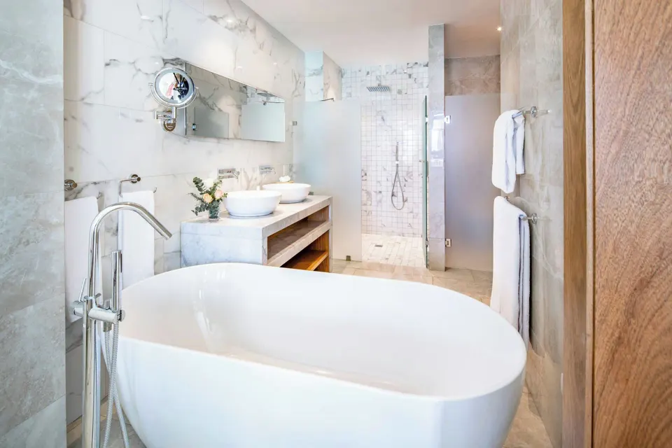 Junior Suite bathroom with soaking tub and walk-in shower at Sanctuary Cap Cana, a Luxury Collection Resort.