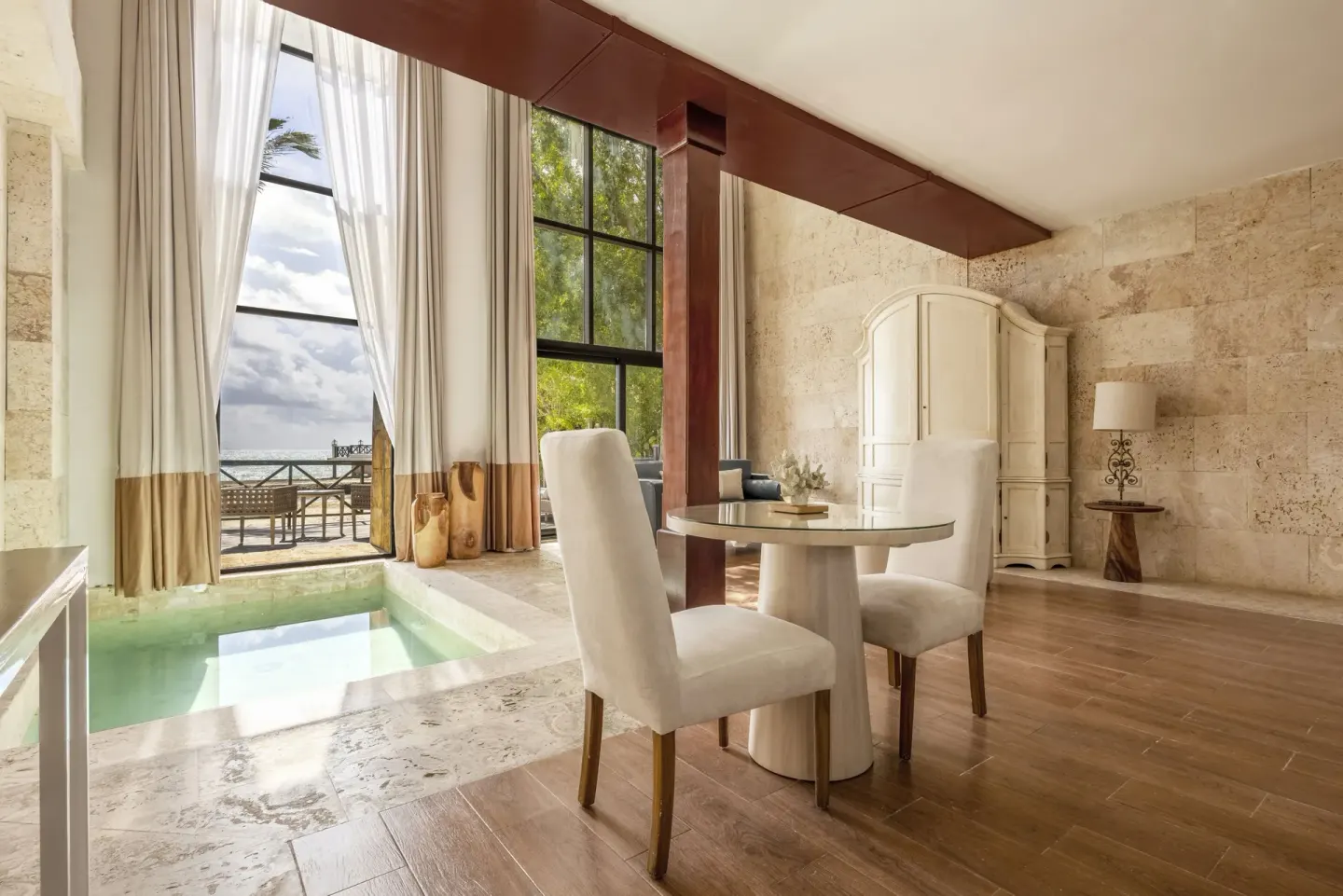 Castle Oceanside suite dining area and plunge pool with balcony at Sanctuary Cap Cana, a Luxury Collection Resort.