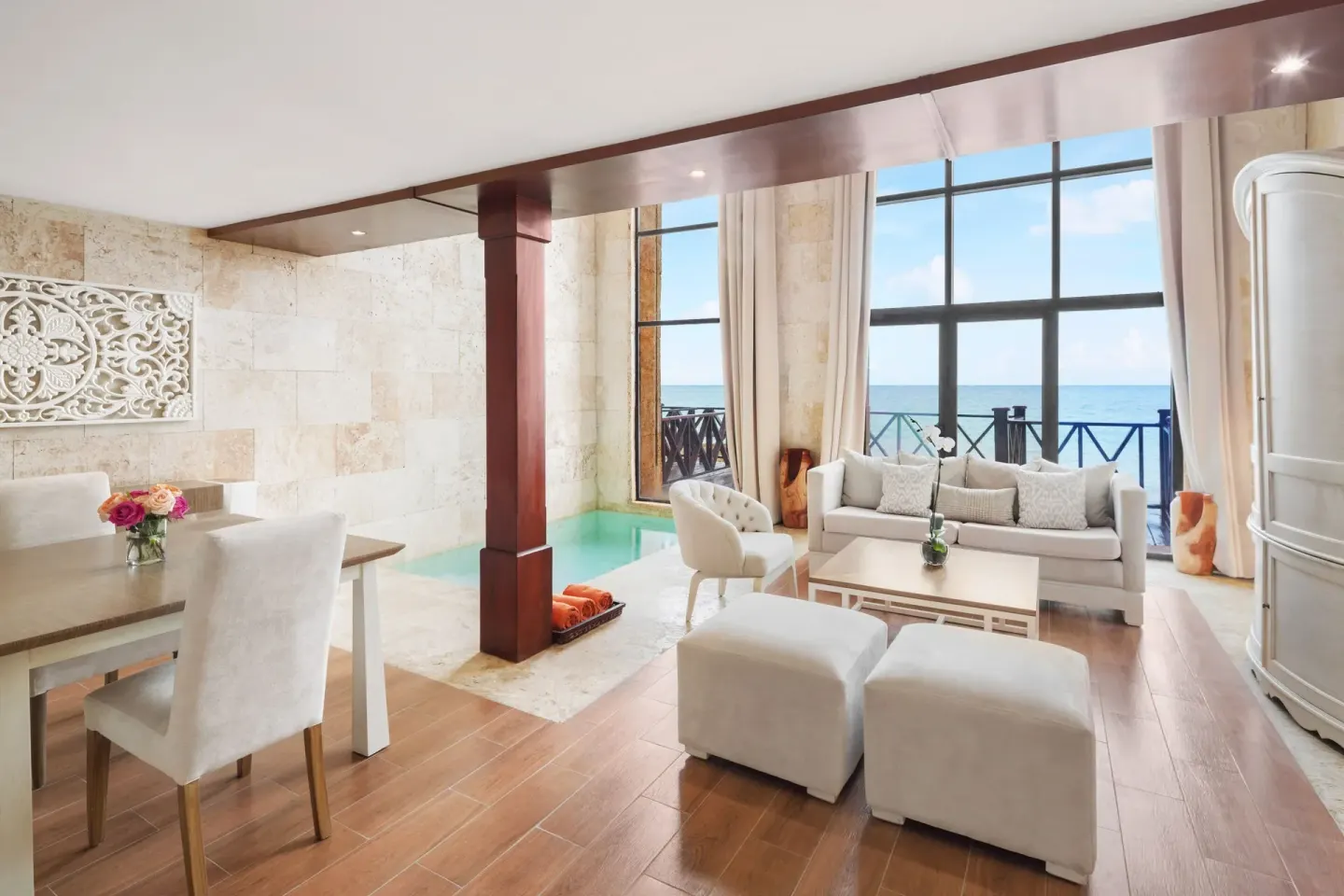 Castle Oceanside suite living area with balcony and ocean view at Sanctuary Cap Cana, a Luxury Collection Resort.