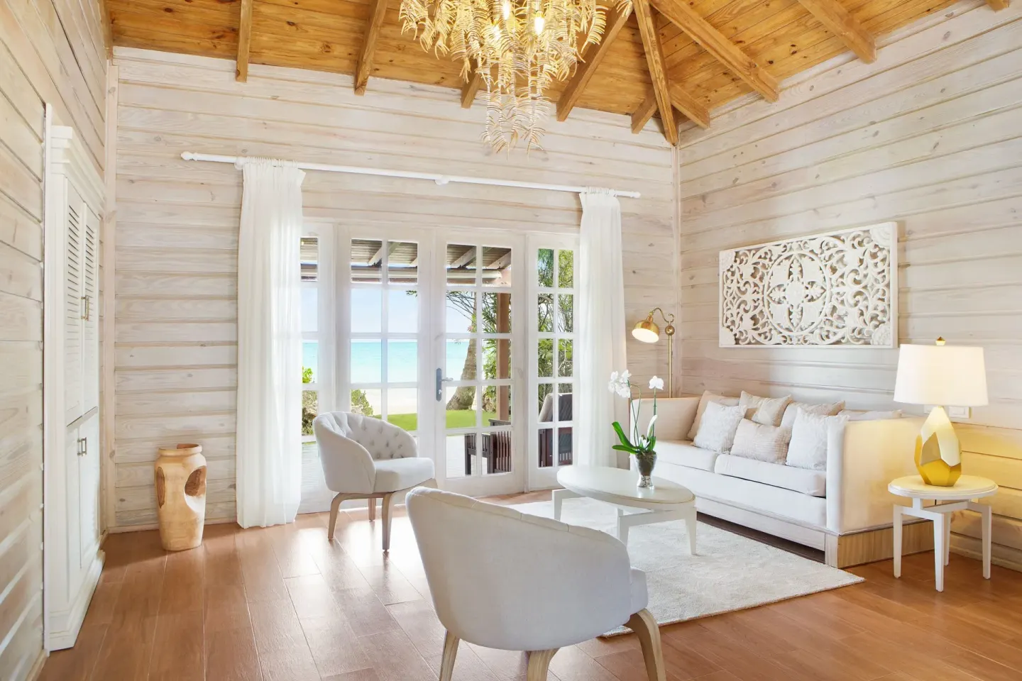 Villa garden view living room with ocean glimpse at Sanctuary Cap Cana, a Luxury Collection Resort.