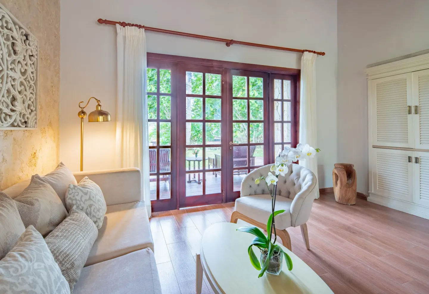 Villa garden view sitting area with glass doors at Sanctuary Cap Cana, a Luxury Collection Resort.