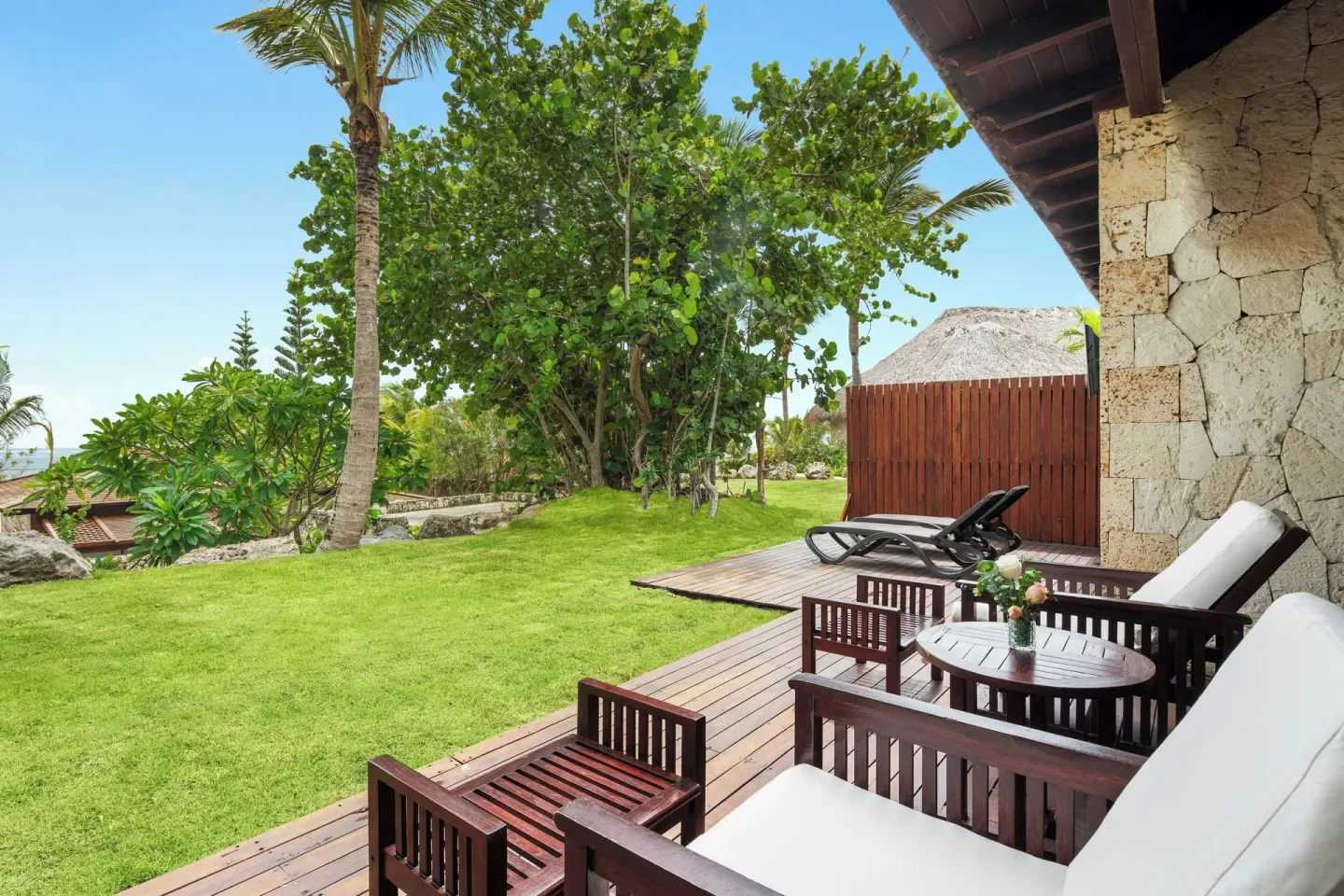 Villa garden view terrace with chairs and loungers at Sanctuary Cap Cana, a Luxury Collection Resort.