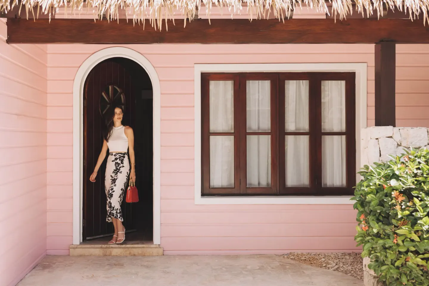 Pink oceanfront villa exterior and arched doorway at Sanctuary Cap Cana, a Luxury Collection Resort.